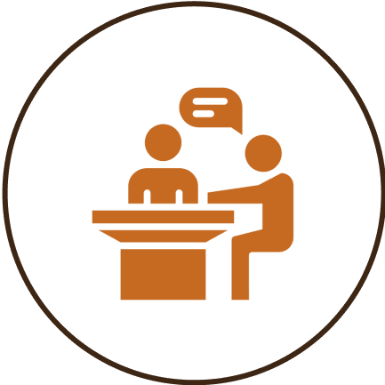 Two figures talking at a table icon.